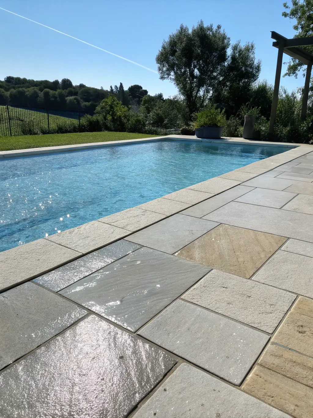 A dirty, stained pool deck in Pembroke Pines, before pool deck cleaning. Focus on the stains and discoloration around the pool area.